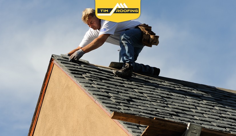 Roofing professionals working on stylish slate tiles, highlighting aesthetics